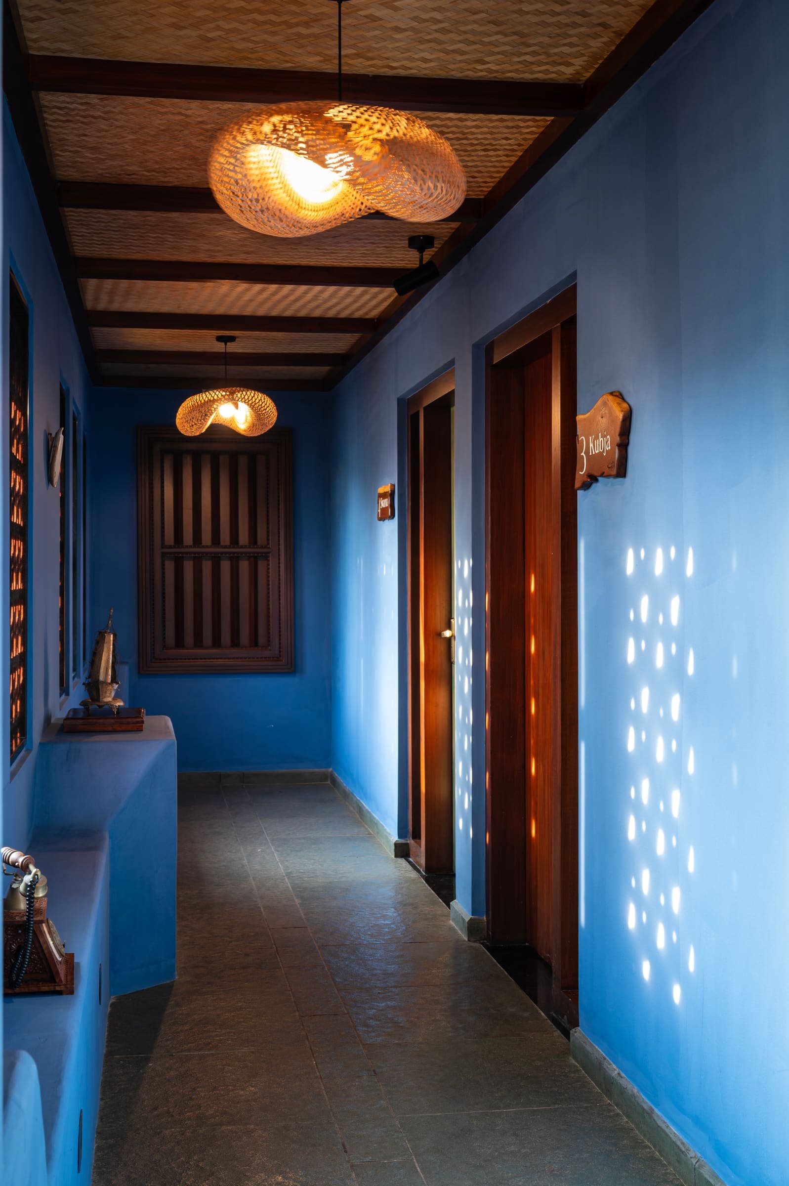 The blue corridor with cane pendant lamps and patterned light