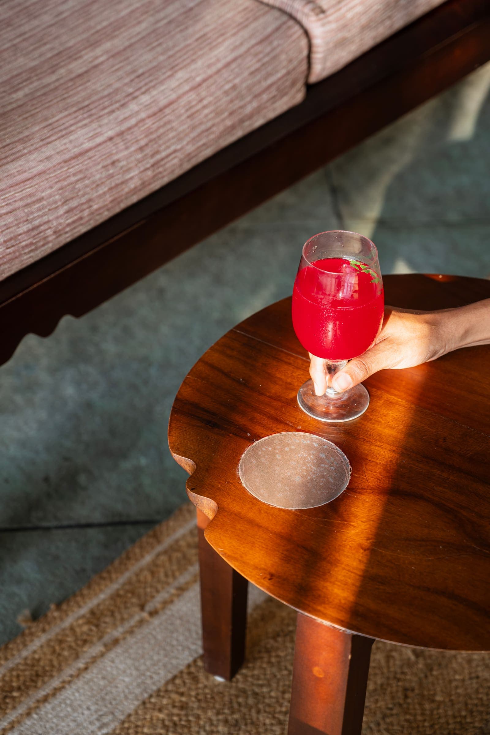 A rose cooler on a carved wooden side table
