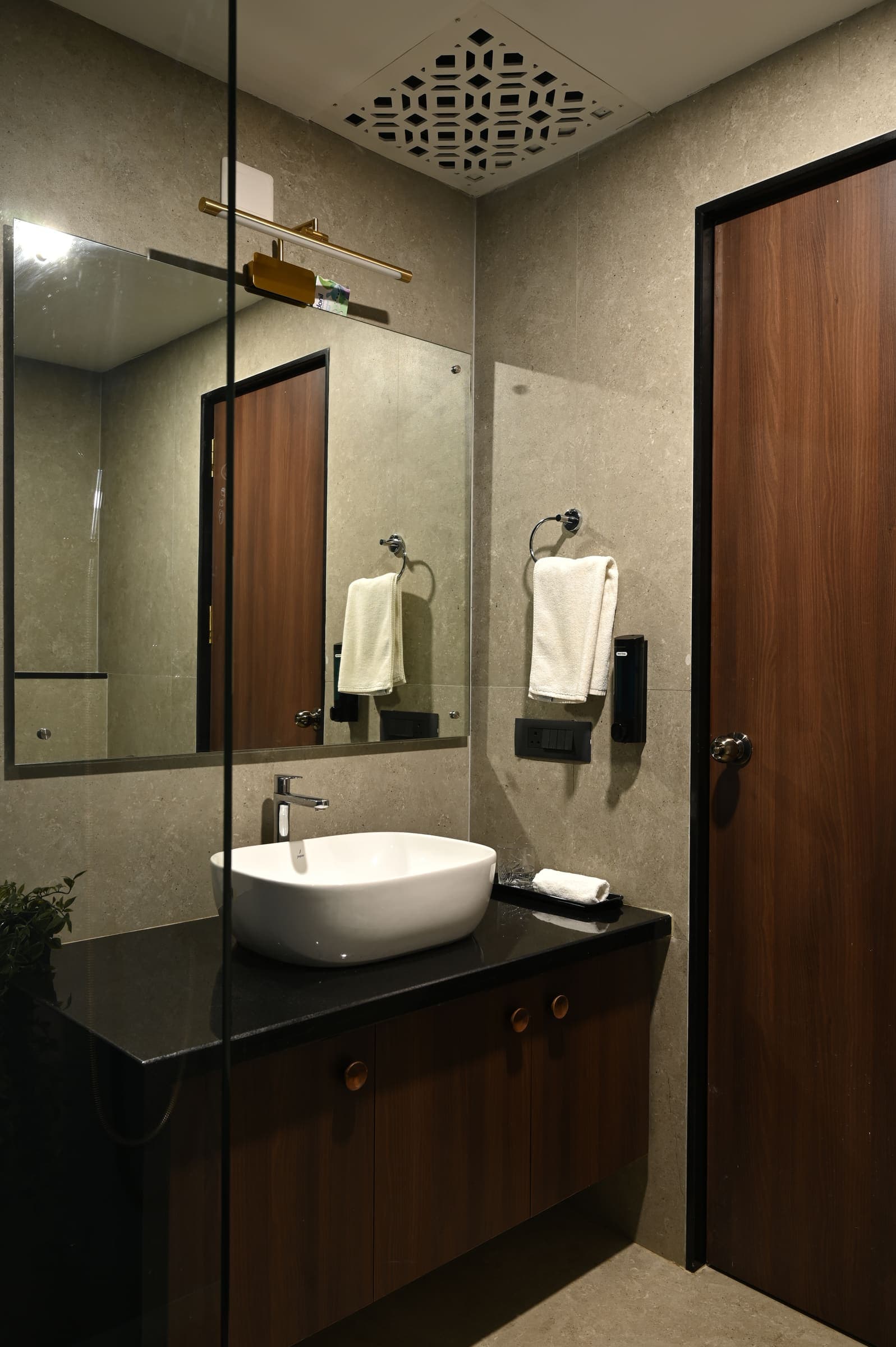 The deluxe bathroom vanity with its vessel basin and lit mirror