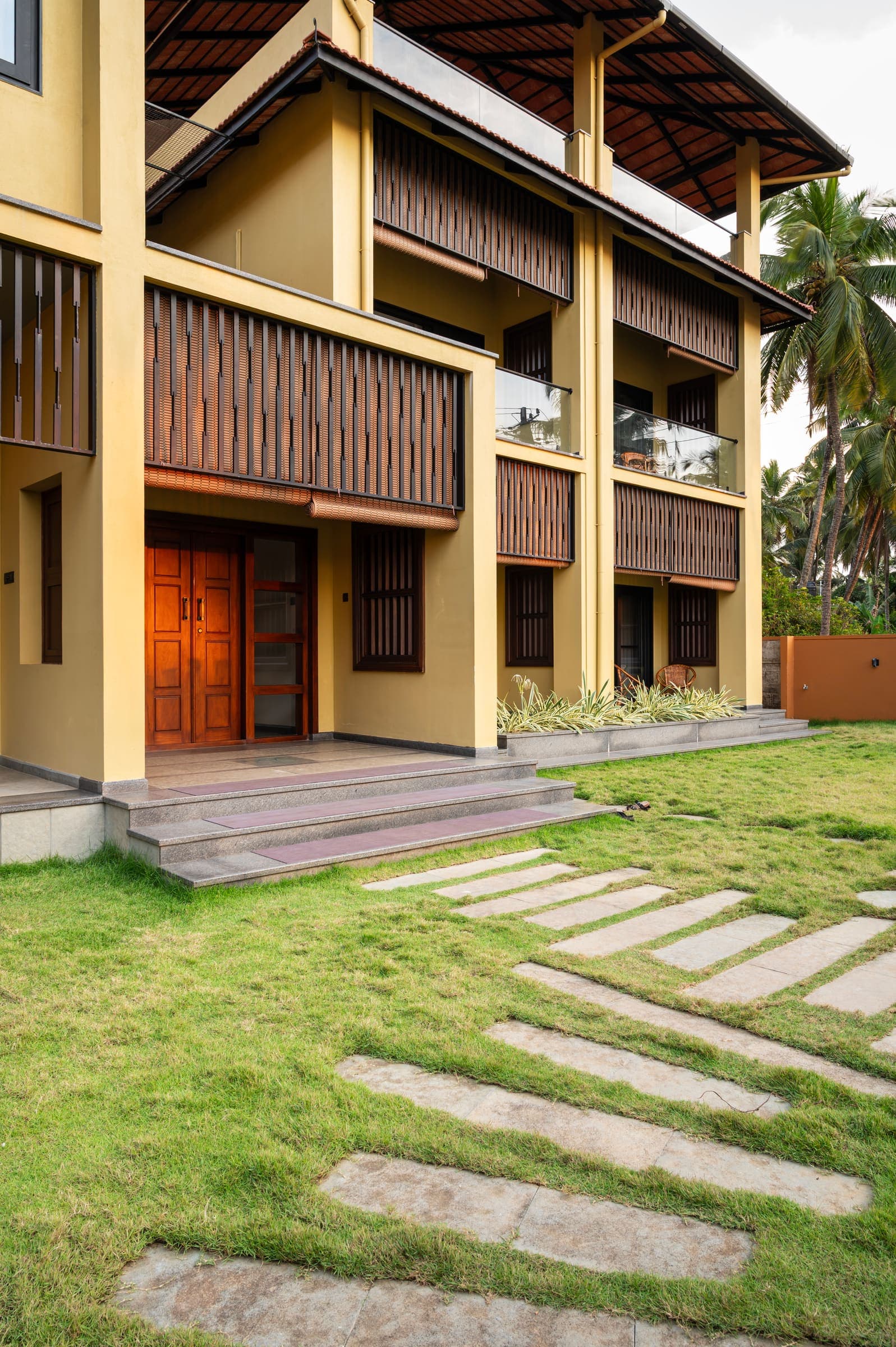 The villa facade with its garden path and stone steps
