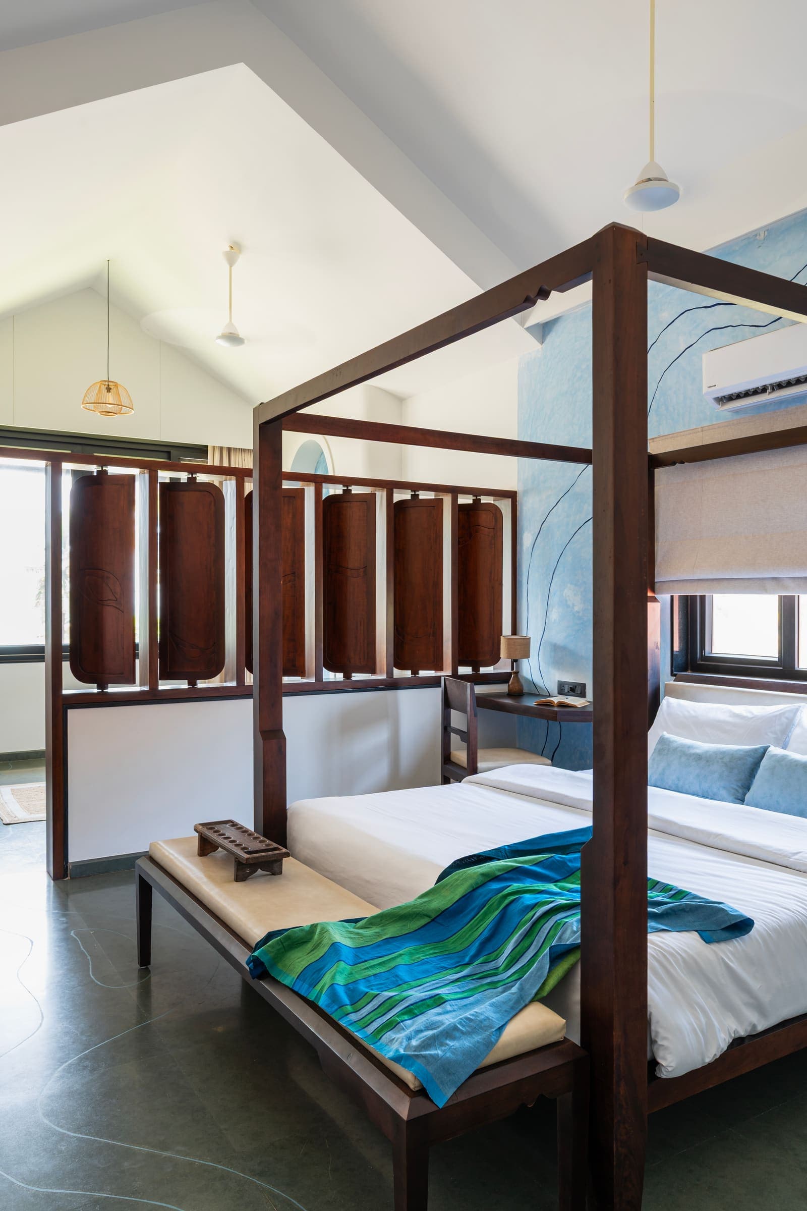 The Varahi master suite with its four-poster bed, vaulted ceiling and carved wooden divider